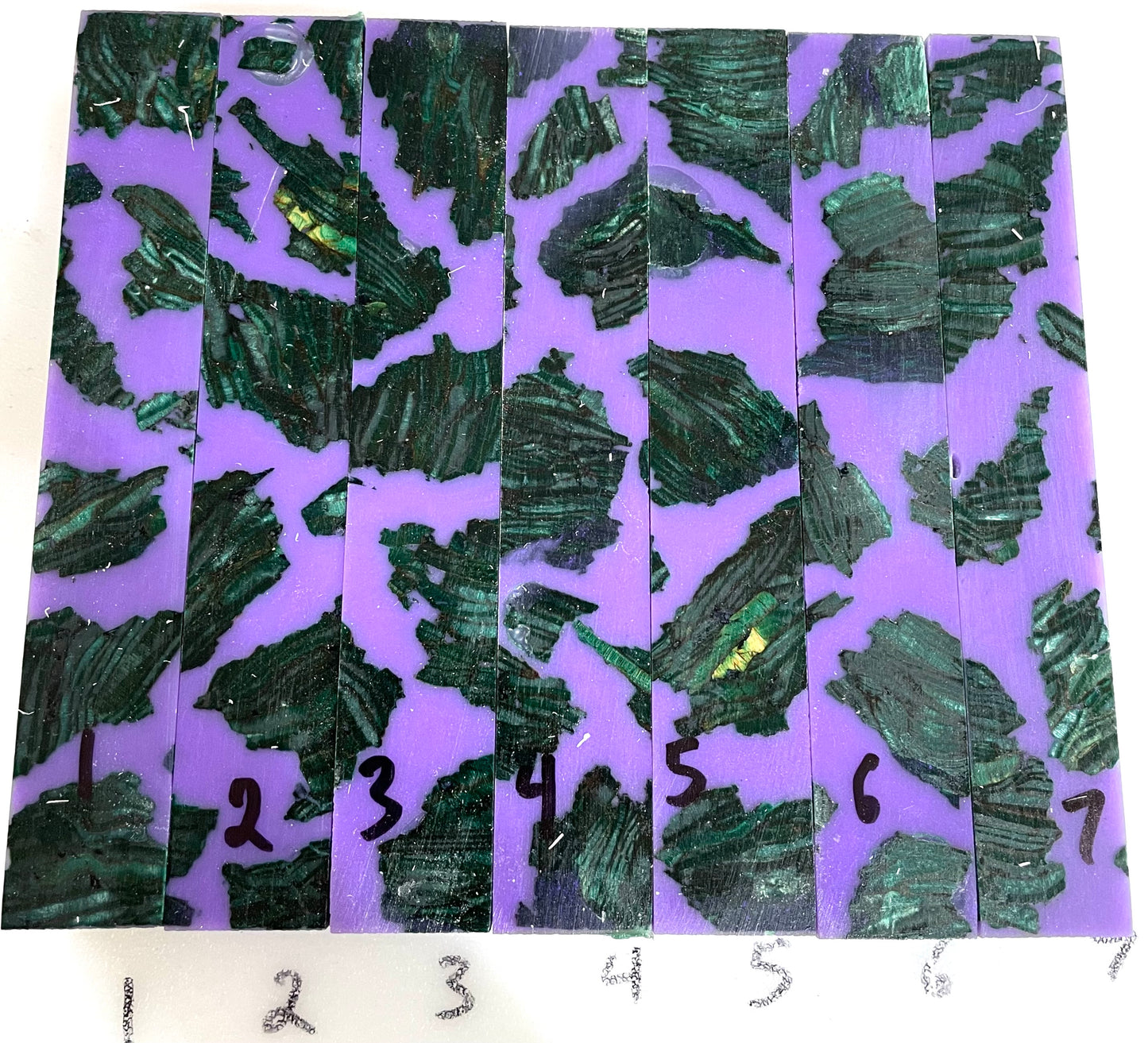Green dye stabilized parallel strand lumber with purple resin